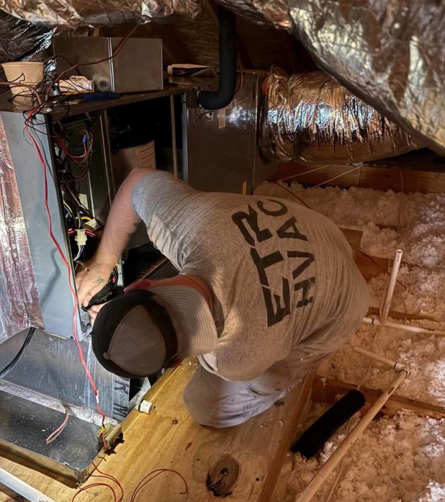 hvac technician working on ducts and ac unit