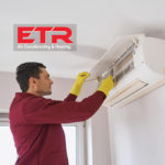 ETR logo and a man cleaning ductless mini split AC