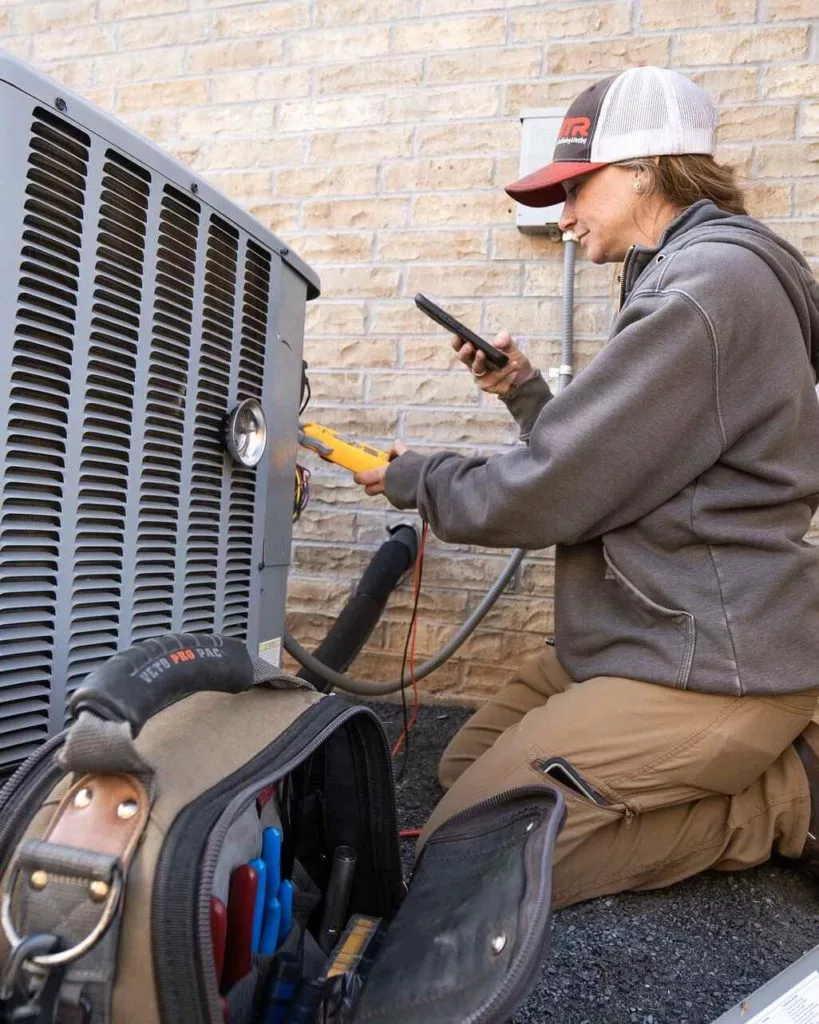 hvac technician performing air conditioning maintenance