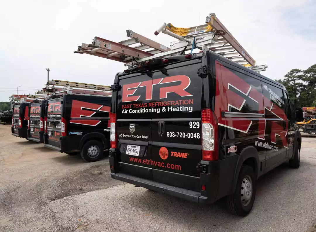 row of etr hvac service vans ready for work