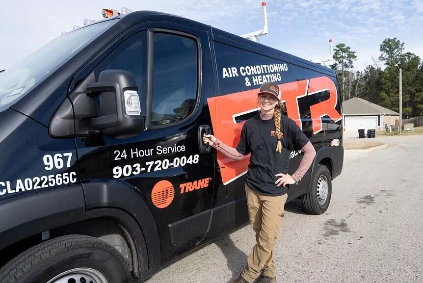 hvac-technician-onsite hvac technician with service truck on job site